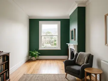 Living room in soft warm white with a deep green feature wall