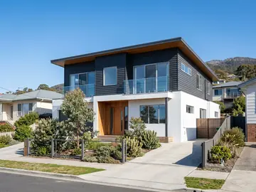 Modern home with a two-tone charcoal and white exterior finish