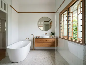 Renovated bathroom with a freestanding bath, VJ panelling and terrazzo floor